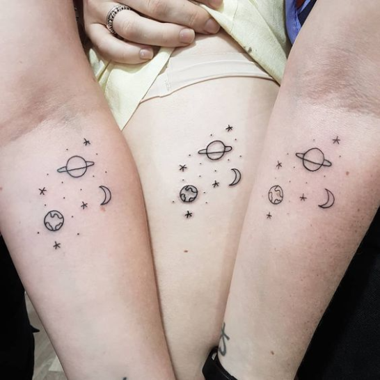 Space-inspired best friend tattoos