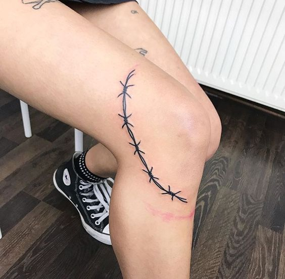 Barbed wire inked on a side around the knee