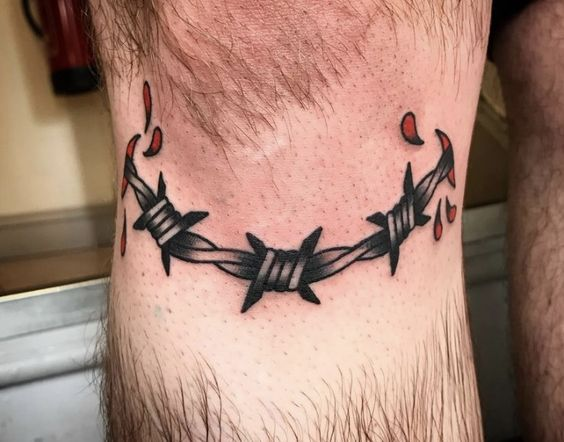 A barbed wire inked around the knee