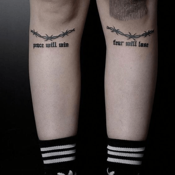 Barbed wires inked under knees