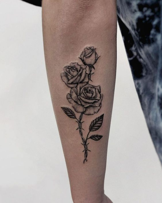 A rose tattoo with barbed wire as a stem