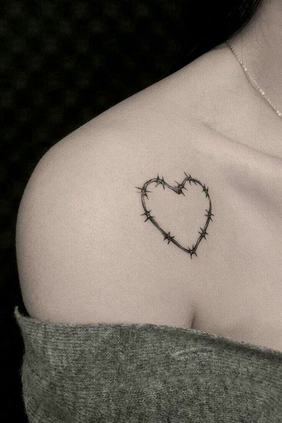 A tattoo of barbed wire in the form of a heart in a minimalistic style