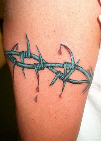 Two blue barbed wires inked on a bicep