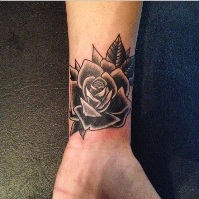 Black rose tattoo on the wrist