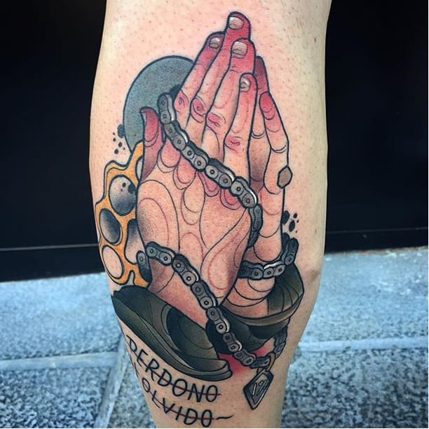 Tattoo with praying hands