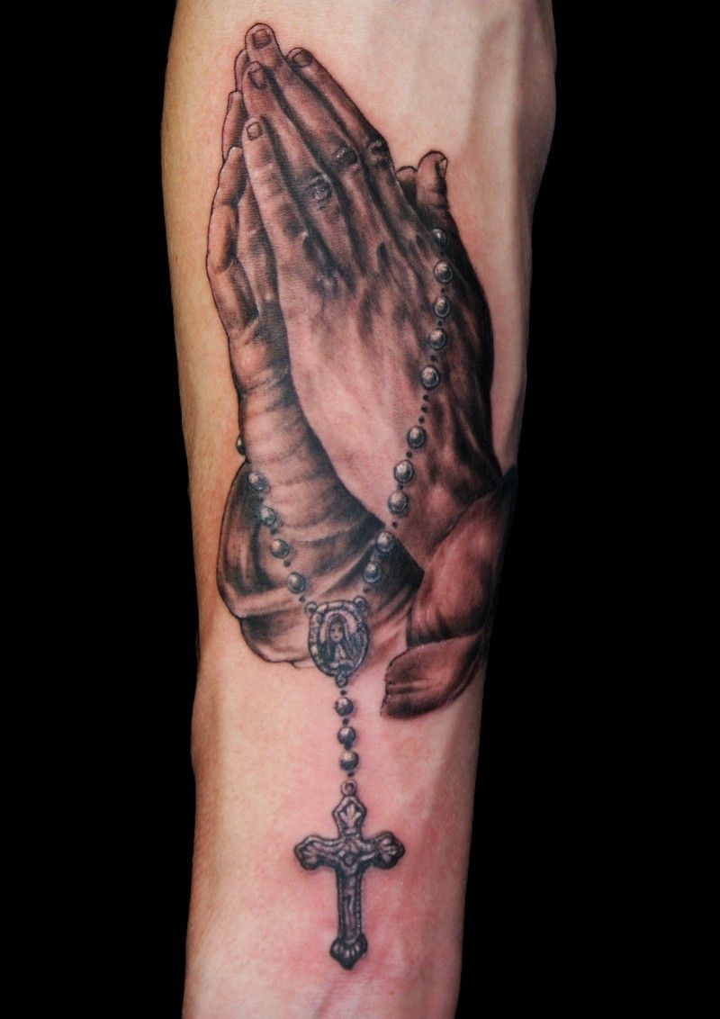 Tattoo with praying hands