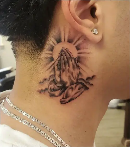 Tattoo with praying hands