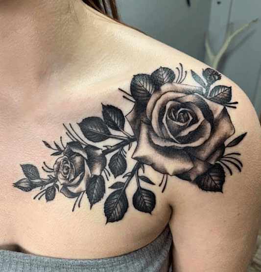 Black rose tattoo on a woman's shoulder