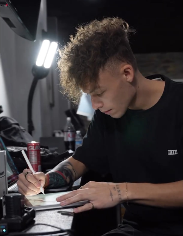 Jesse Tattoo working on a tattoo design in his studio.