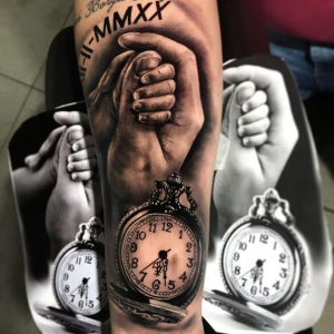 child's hand with birth clock