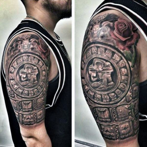 A man with an Aztec calendar tattoo on the arm inked as a half-sleeve