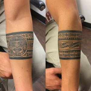 Two Aztec tribal tattoos displayed on a man's arm