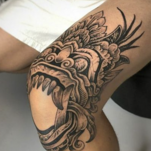 Aztec-inspired dragon tattoo on the knee