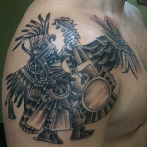 The tattoo of an Aztec symbol, the God of The Sun, on the shoulder