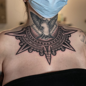 Female with Aztec hummingbird tattoo on the neck