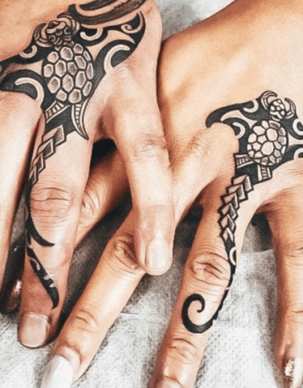Matching tattoos in Polynesian style