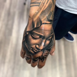 Catholic Mary Statue Tattoo on the hand