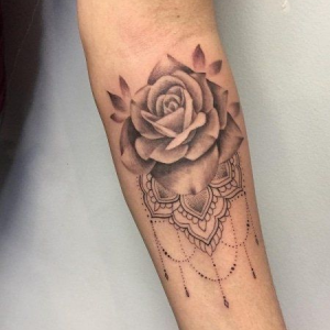 Rose tattoo on the forearm