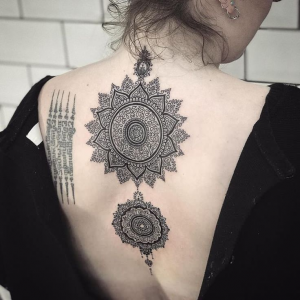 Two circle mandala tattoos on the back