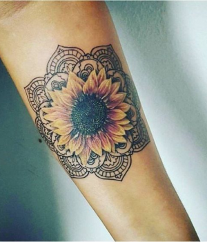 Colored sunflower mandala tattoo on the forearm