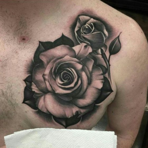 Black rose tattoo on the chest