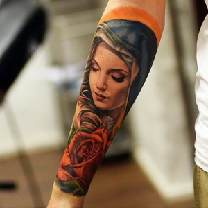 Colored Catholic Mary with Roses Tattoo on the forearm