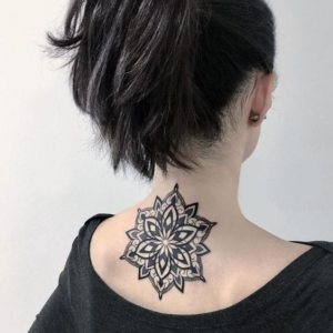 Circle mandala tattoo on the back of the neck