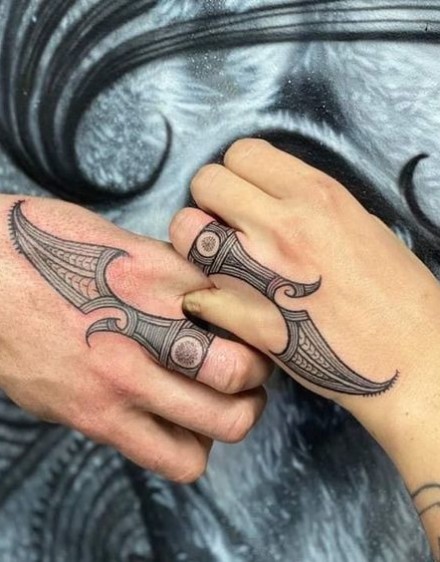 Matching tattoos in Polynesian style