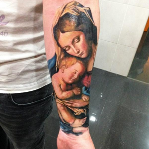Colored Catholic Mary with Jesus Tattoo on the forearm