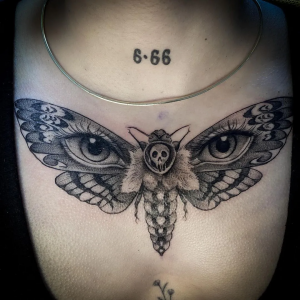 Moth tattoo on the female chest