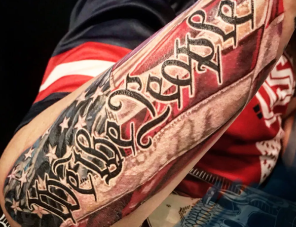 We the People with a colourful American Flag inked on the forearm