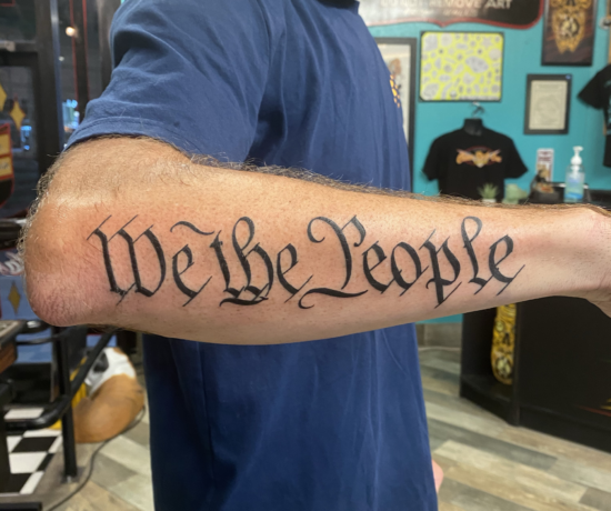 We The People inked on the forearm as a quote