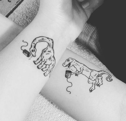 Couple Tattoos with Dinosaur Motifs