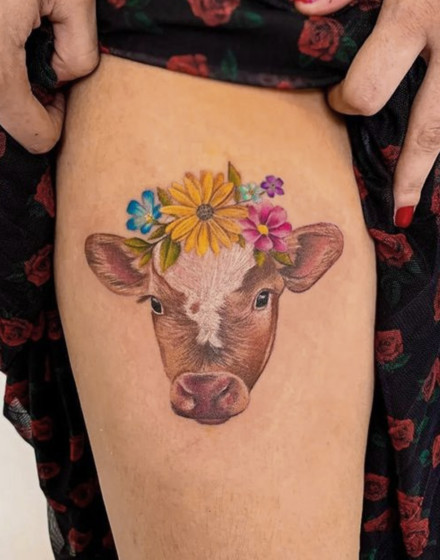A Cow Tattoo With Flowers