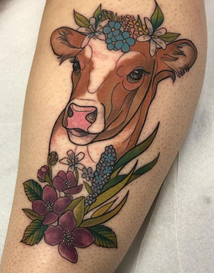 A Cow Tattoo With Flowers