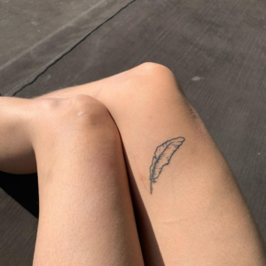 Dove's Feather inked on the upper thigh