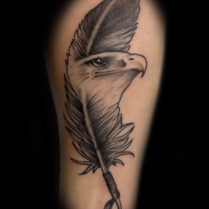 A tattoo of an eagle's head combined with a feather