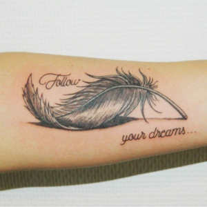 Feather inked with a motivational inscription