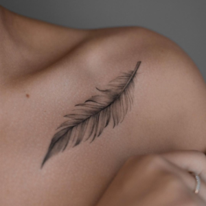 Minimalistic Feather inked on a shoulder