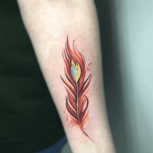 Phoenix feather with flames inked on a wrist