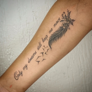 Feather tattoo with an inscription