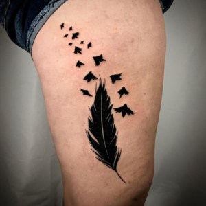 Thigh feather tattoo with birds
