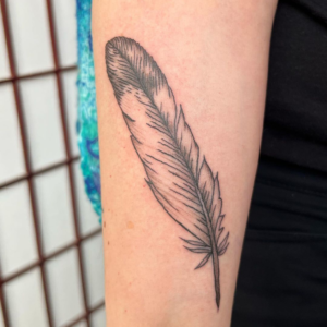 Eagle's Feather in minimalistic style inked on the arm