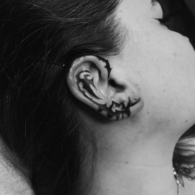 Ear tattoo by Francis Logan